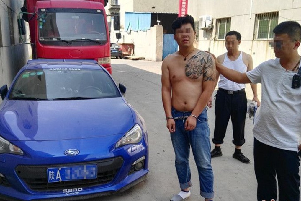 One of the drivers arrested, flanked by a police officer. Photo: Hsw.cn