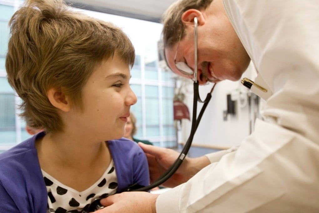 A 2012 photo of Emily Whitehead being checked by oncologist Stephan Grupp at the Children’s Hospital of Philadelphia. Photo: AP