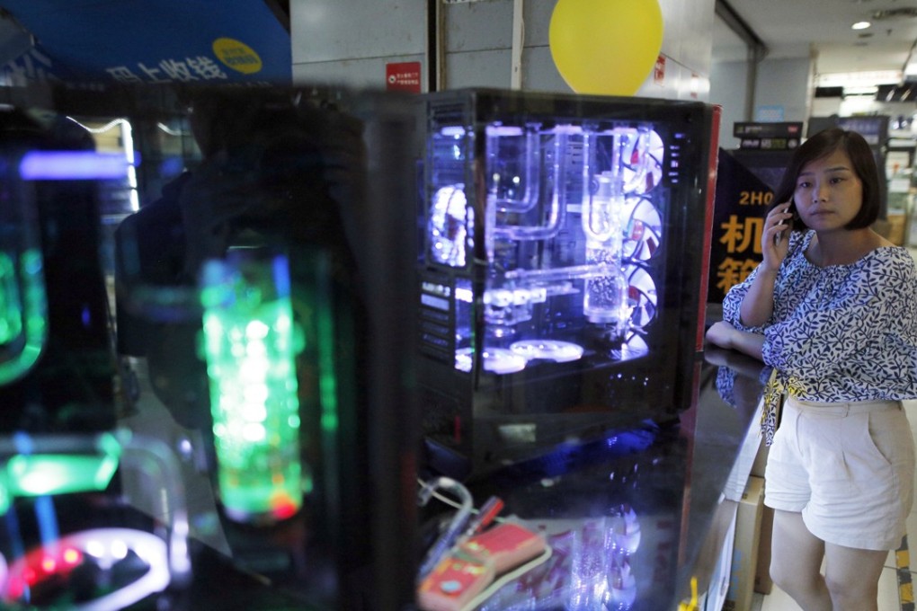 A shopper looking at electrical goods at a shopping mall in Beijing. Photo: EPA