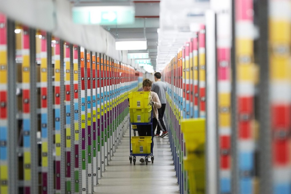 A worker at the Amazon logistics centre in Koblenz, Germany. Photo: EPA/THOMAS FREY