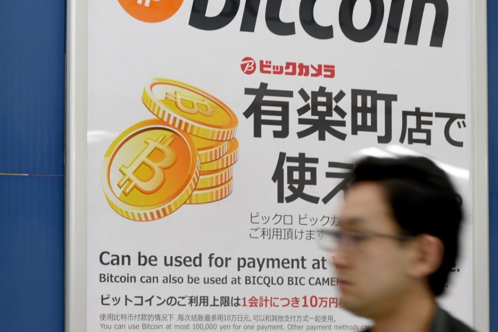 A signboard informing customers that Bitcoin can be used for payment at a store in Tokyo. Photo: AFP