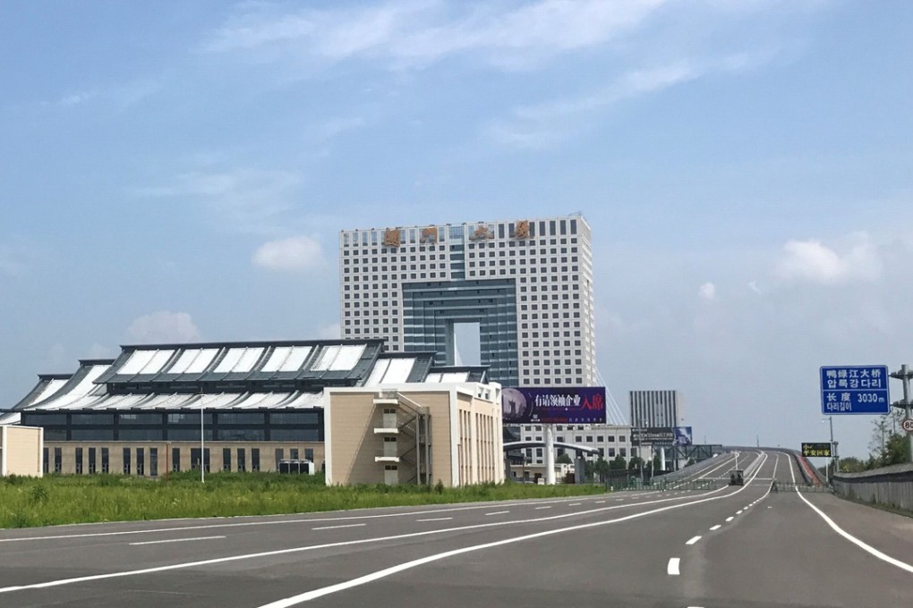 An empty road near the unfinished New Yalu River bridge and the empty Chinese customs building in Dandong, Liaoning, last month. Photo: Reuters