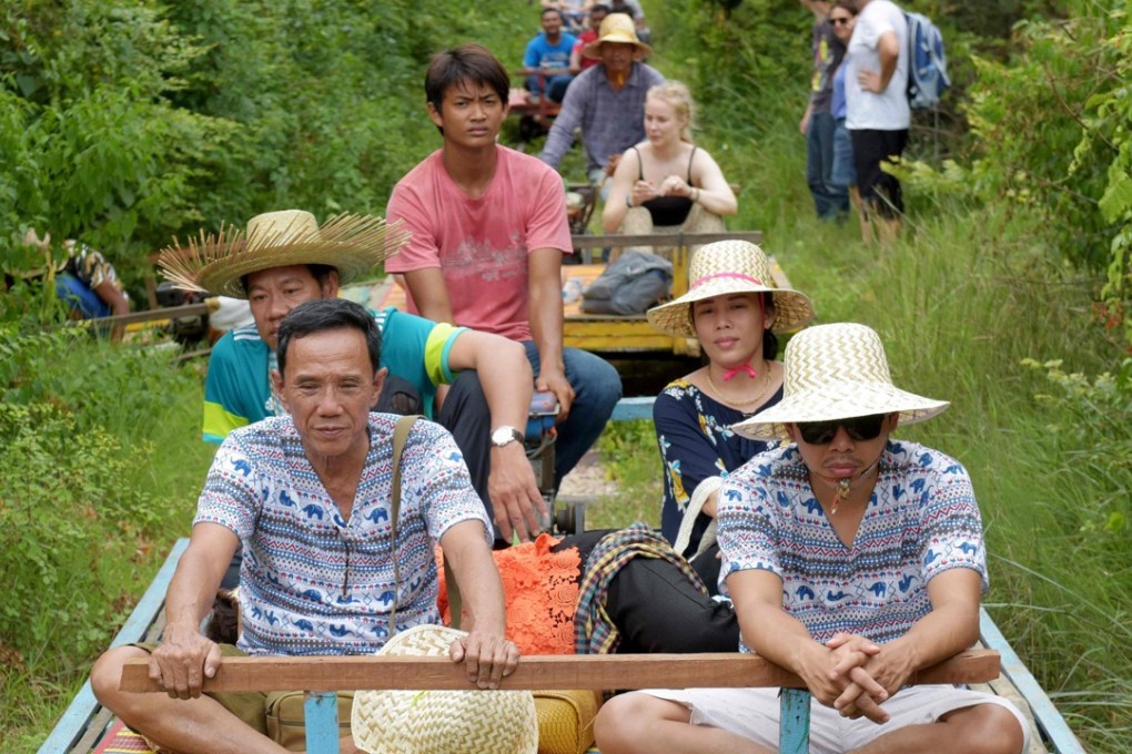 Tourists ride bamboo-lined trolleys on one of Cambodia’s abandoned colonial-era train tracks in Battambang. Photo: AFP