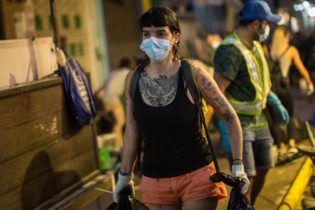 Macau residents volunteer to clean up debris on the streets on August 25, in the wake of Typhoon Hato. Natural disasters that have made the headlines recently magnify the consequences of the political and social choices we’ve made. Photo: EPA