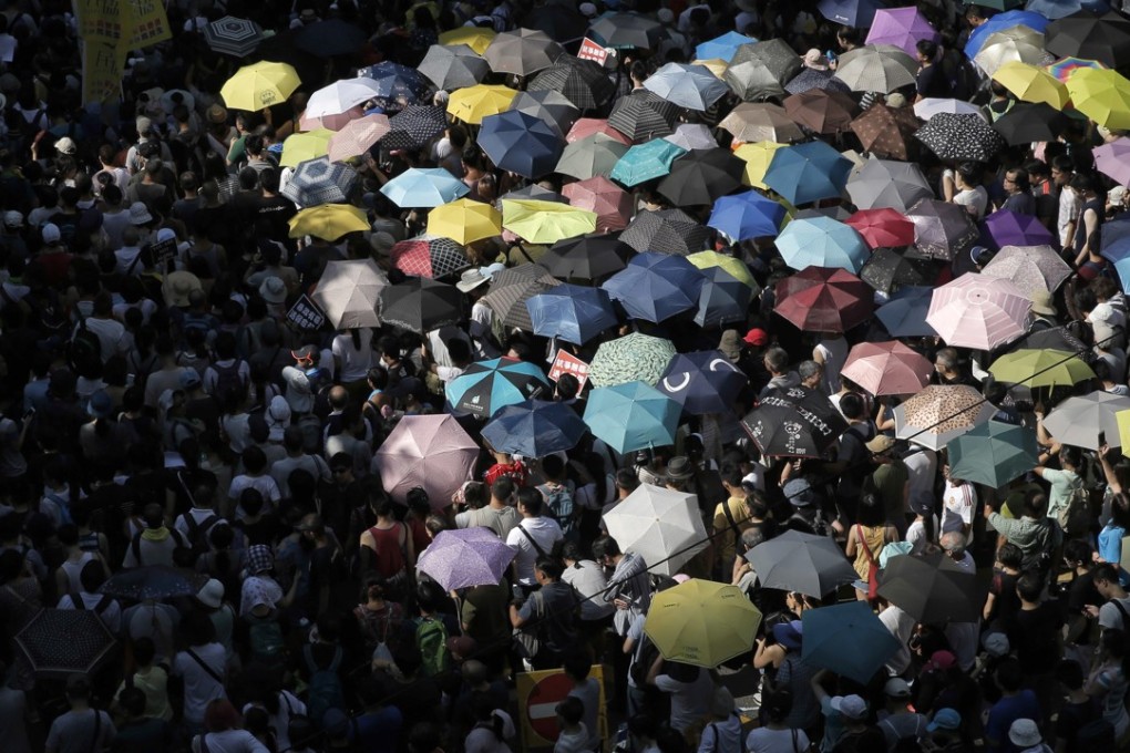 Protesters use umbrellas as shelter from the sun at a demonstration against the jailing of pro-democracy activists. Photo: AP