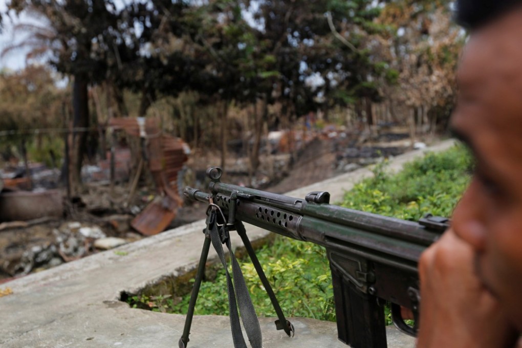 A police officer guards the remains of a house which was burnt down during the violence in Maungdaw, northern Rakhine state, Myanmar. Photo: Reuters