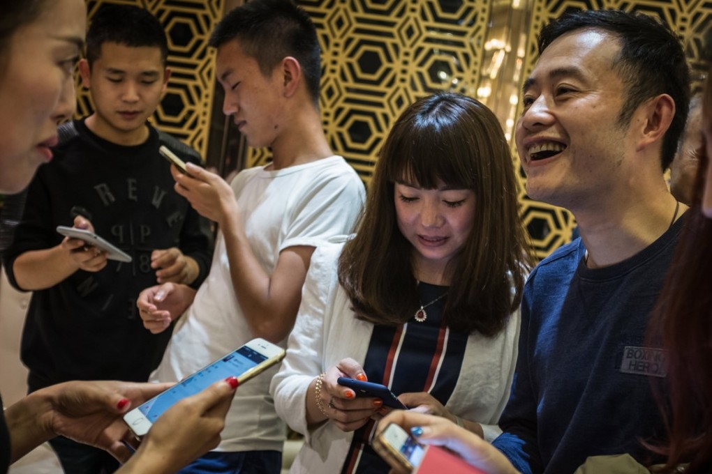 Chinese bitcoin “miners” add each other on social media after the first China Bitcoin Miner Conference, in Chengdu, Sichuan province, last October 22. Photo: EPA