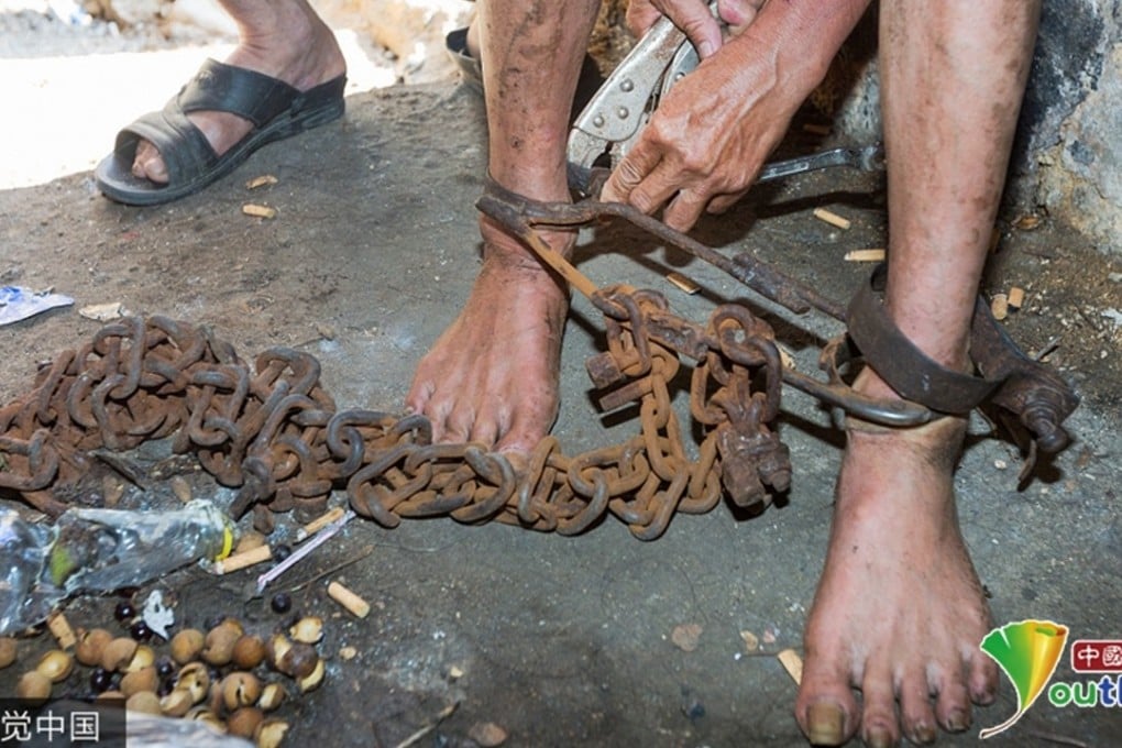 A man users wire cutters to free Xu from the shackles around his ankles. A hospital has agreed to assess his mental health state and provide a rehabilitation programme for him. Photo: Handout