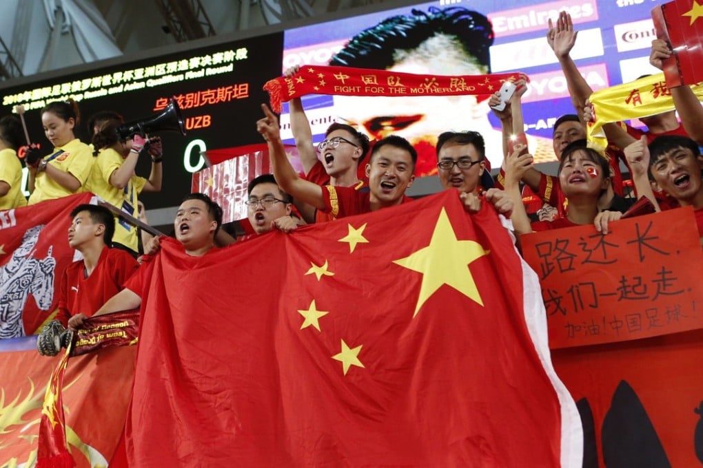 Chinese fans wave the national flag against Uzbekistan. Photo: AFP