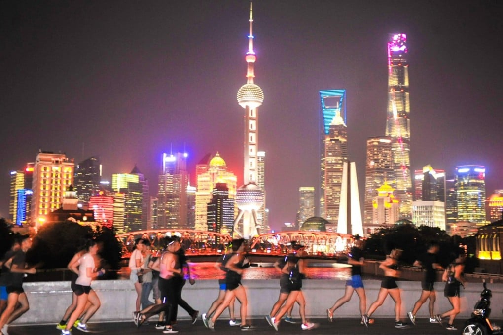 This photo taken on July 28, 2017 shows people running at night in Shanghai. Photo: AFP