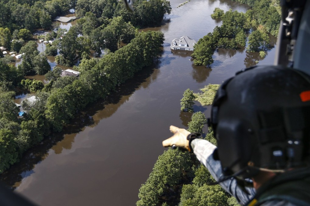 Rescuers scans flooded areas from the air. Photo: AP