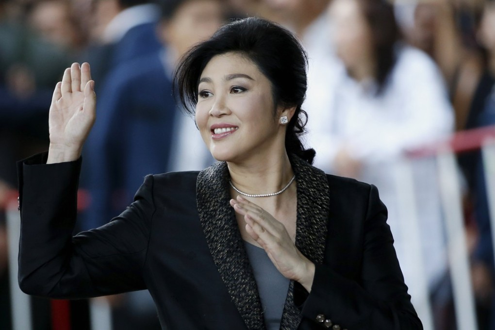 Yingluck Shinawatra waves to supporters as she arrives to deliver closing statements in her trial at the Supreme Court in Bangkok. Photo: EPA