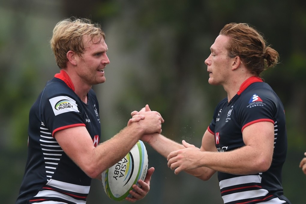 Jamie Hood (left) and Jack Neville celebrate a try on day two of the opening round of the Asia Rugby Sevens Series. Photos: HKRU