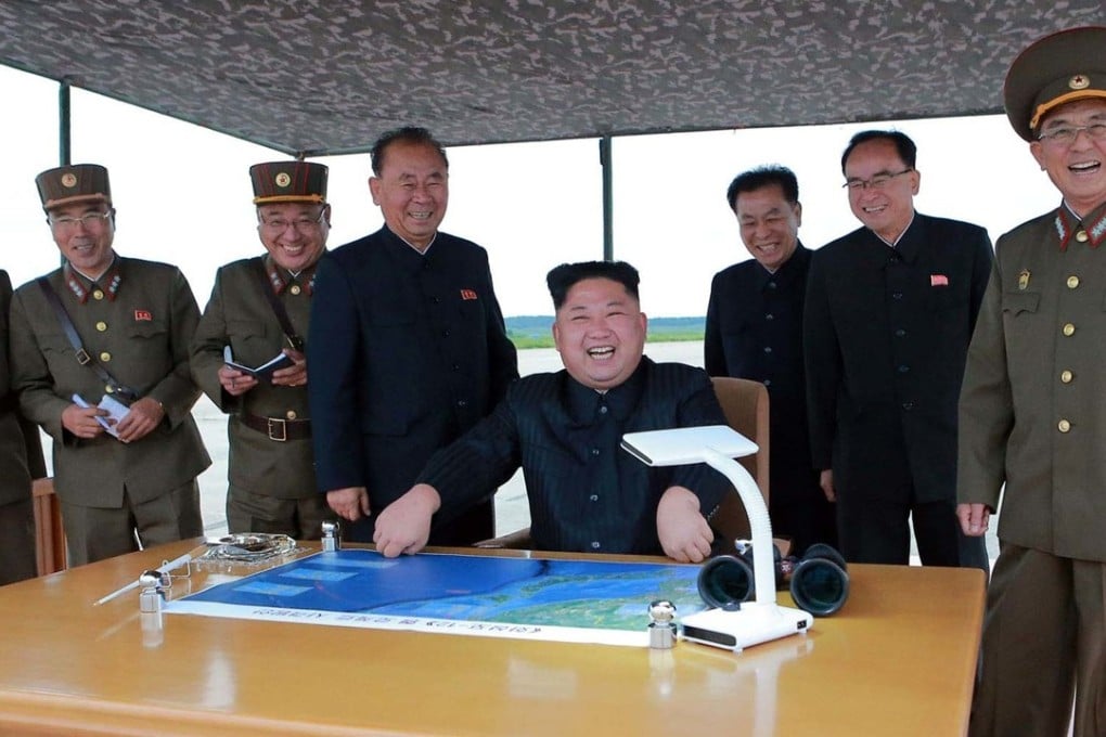North Korean leader Kim Jong-un smiles as he watches the test launch of a Hwasong-12 intermediate-range missile. Photo: AP