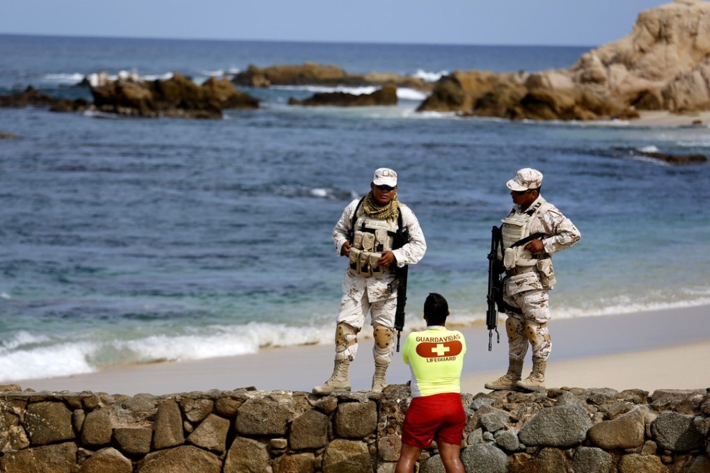 Mexican soldiers patrol Palmilla Beach where three men were killed by a group of men with automatic weapons in San Jose del Cabo. Photo: TNS