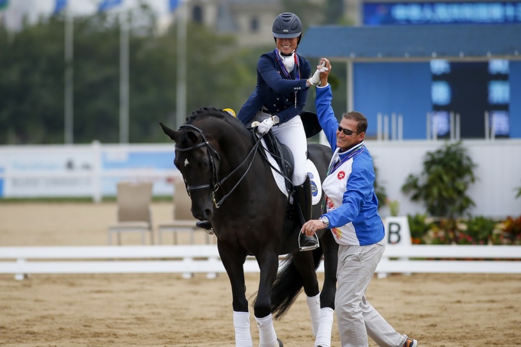 Jacqueline Siu is congratulated by coach Nick Burton after winning silver in dressage at Tianjin Metropolitan Polo Club. Photos: HKJC