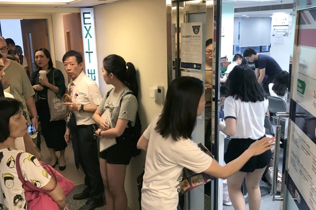 Anxious visa applicants and their families queued up at the British visa centre in Causeway Bay on Monday. Photo: Nora Tam