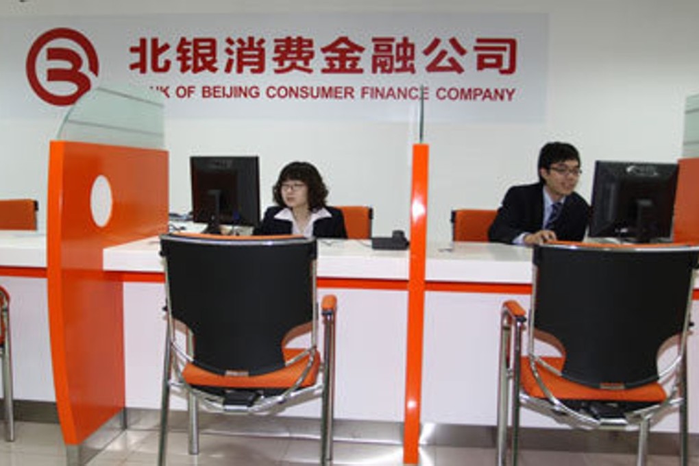 Staff work at a branch of Bank of Beijing Consumer Finance Company. The firm and its four executives were punished over the weekend for malpractice. Photo: Handout.