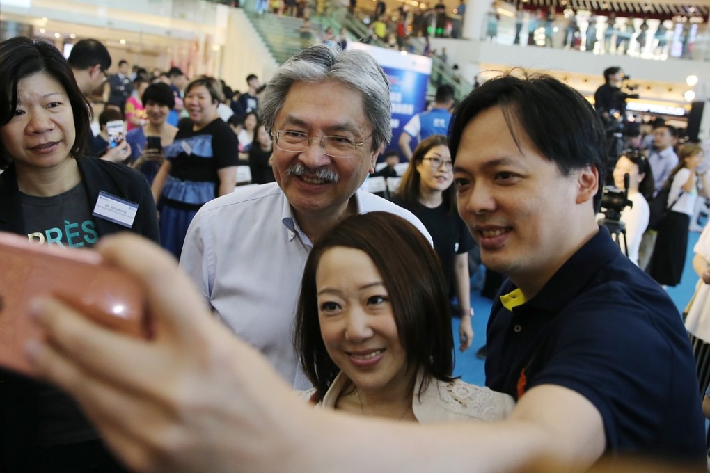 Former Financial Secretary John Tsang Chun-wah take a selfie with fans. Photo: Sam Tsang