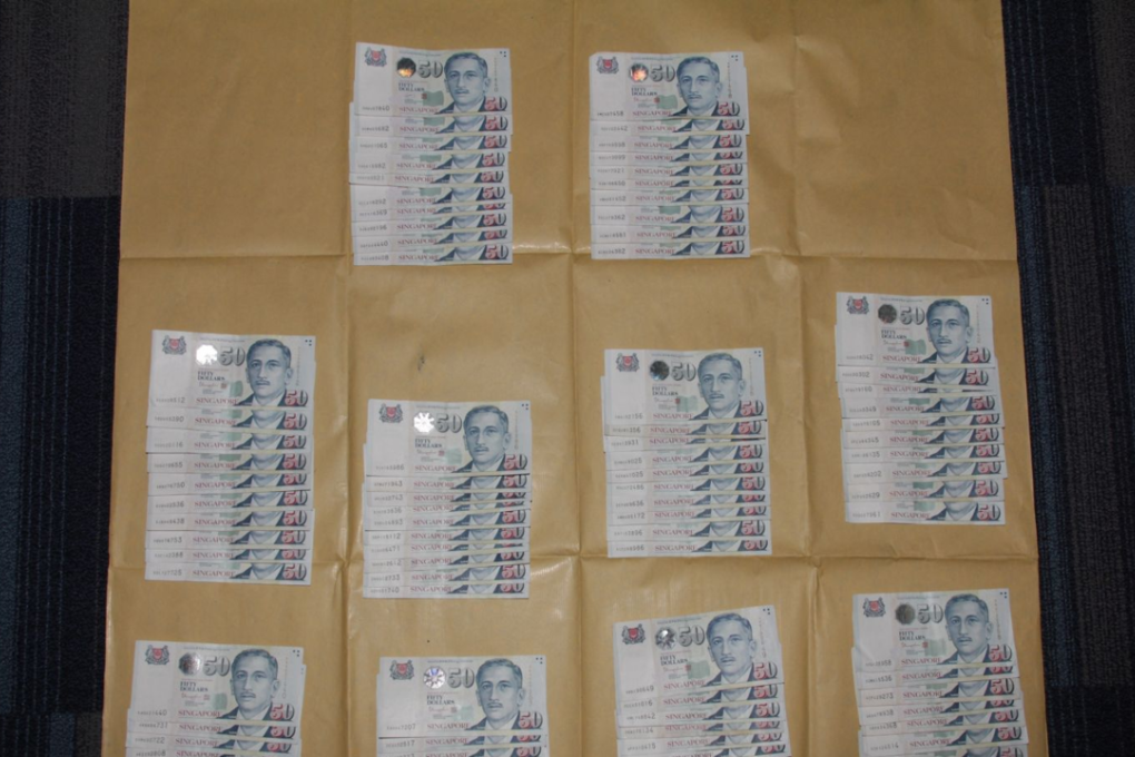 The money recovered from the two men. Photo: Singapore Police Force
