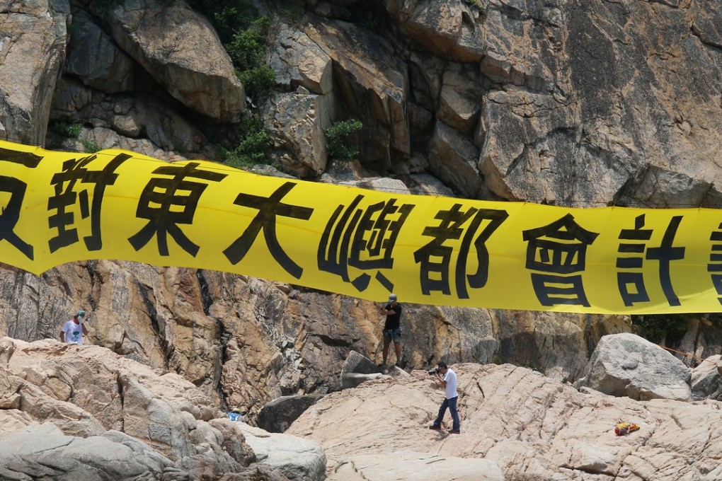 Members of the Save Lantau Alliance hang a banner urging a halt to the East Lantau Metropolis plan, at Kau Yi Chau last June. Photo: K. Y. Cheng