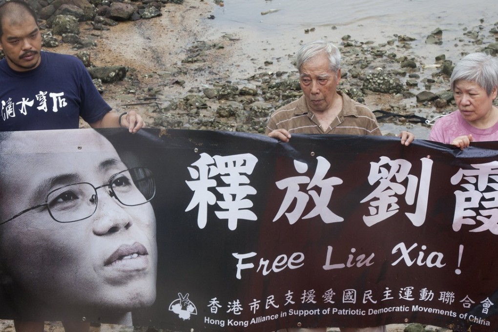 Hong Kong activists protesting for the release of Liu Xia, the wife of the Nobel Peace Prize winner Liu Xiaobo. Liu Xia is still living under house arrest in Beijing, even though she has not been convicted of any crime. The case has drawn widespread condemnation from governments and rights groups around the world. Photo: EPA