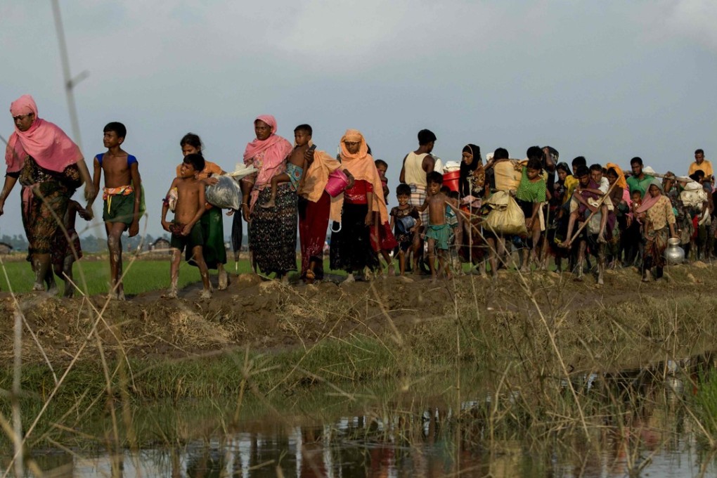 Displaced Rohingya refugees from Rakhine state carry their belongings as they flee violence. Photo: AFP