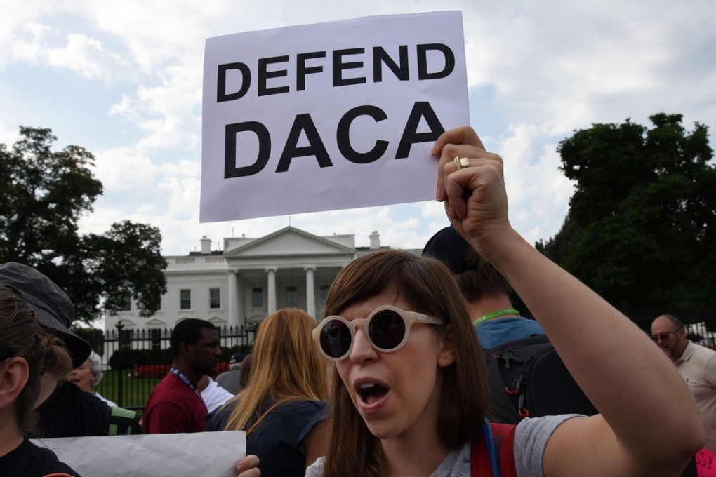 Protesters hold up signs during a rally supporting Deferred Action for Childhood Arrivals, or DACA, outside the White House. Photo: TNS