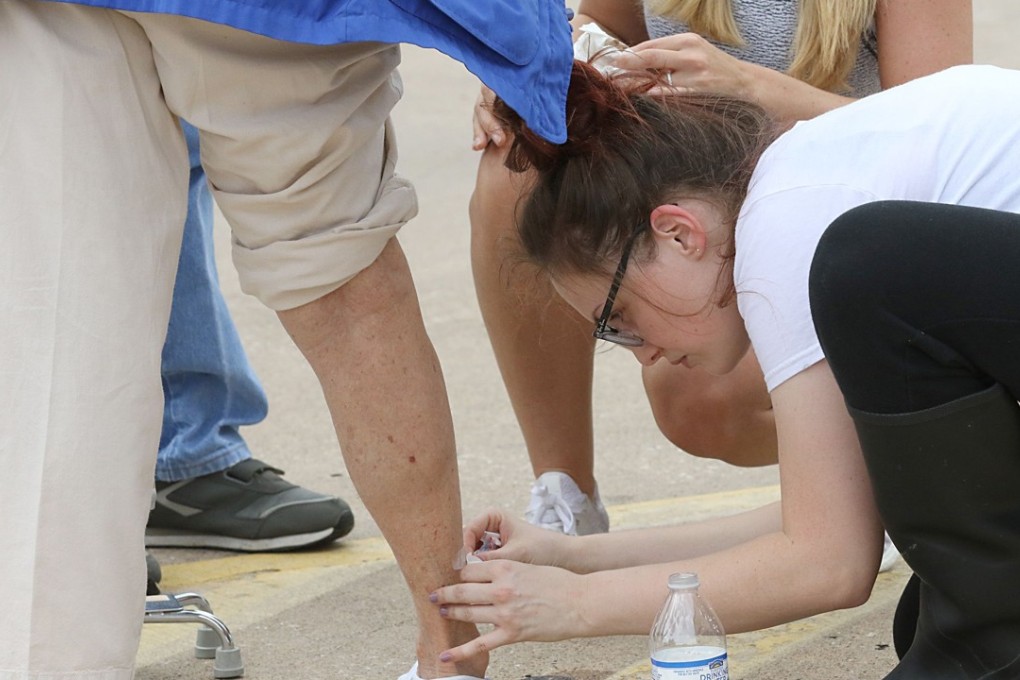 An elderly lady's leg is bandaged after being cut while evacuating from the toxic sludge of floodwaters in Houston on August 30, 2017. The floods could cause diseases from hookworms. Photo: AFP