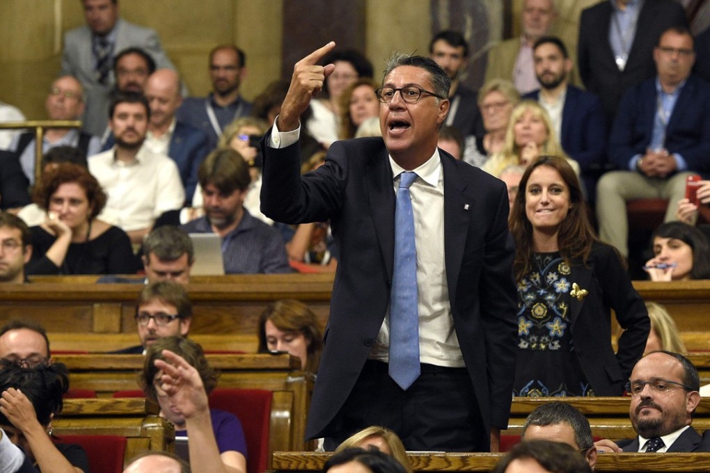 Popular Party PP spokesman Xavier Garcia Albiol protests from his seat. Photo: AFP