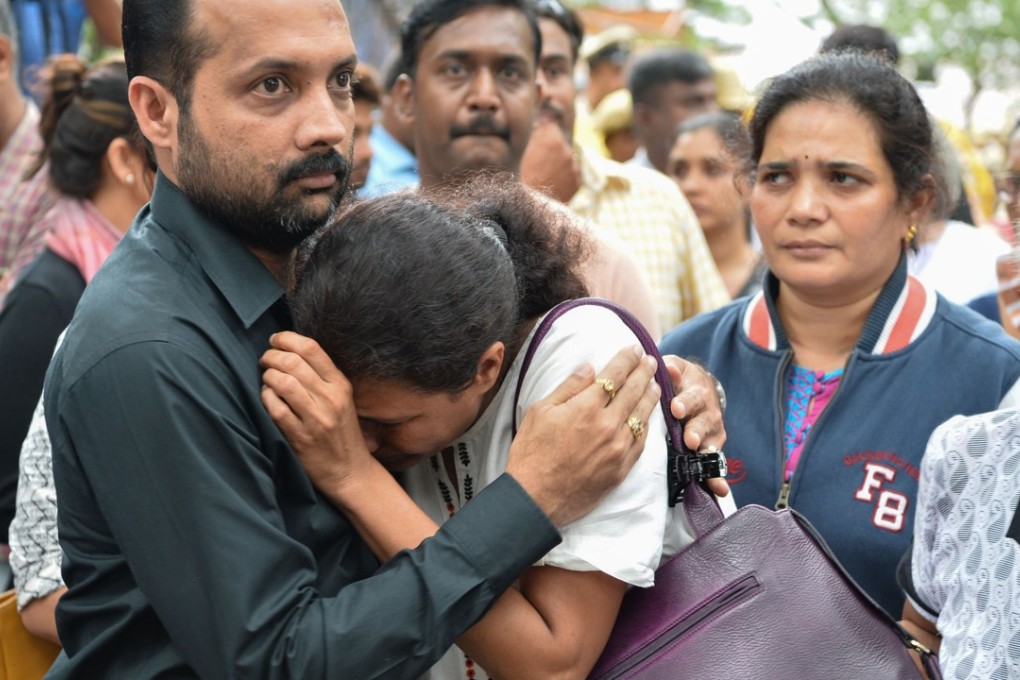 Indian journalist Gauri Lankesh's sister Kavitha Lankesh is consoled by a relative. Photo: AFP