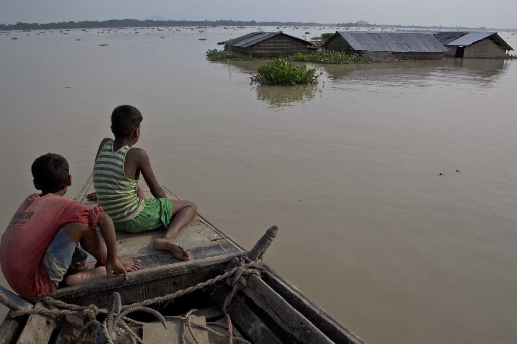 A boat offers refuge, with homes under floodwaters in Morigaon district, in the northeastern Indian state of Assam, on August 15. Heavy monsoon rains this year have unleashed landslides and floods, killing hundreds and displacing millions more across northern India, southern Nepal and Bangladesh. Photo: AP