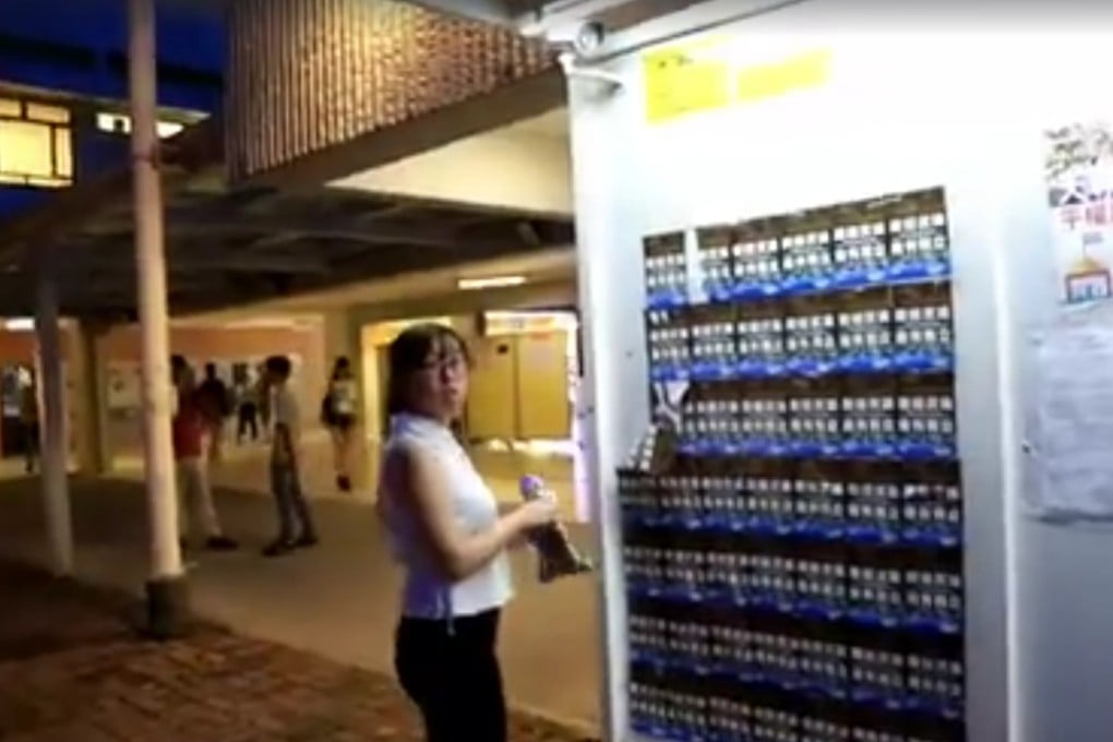 A woman claiming to be a student of the university is filmed tearing off the controversial posters. Photo: SocREC