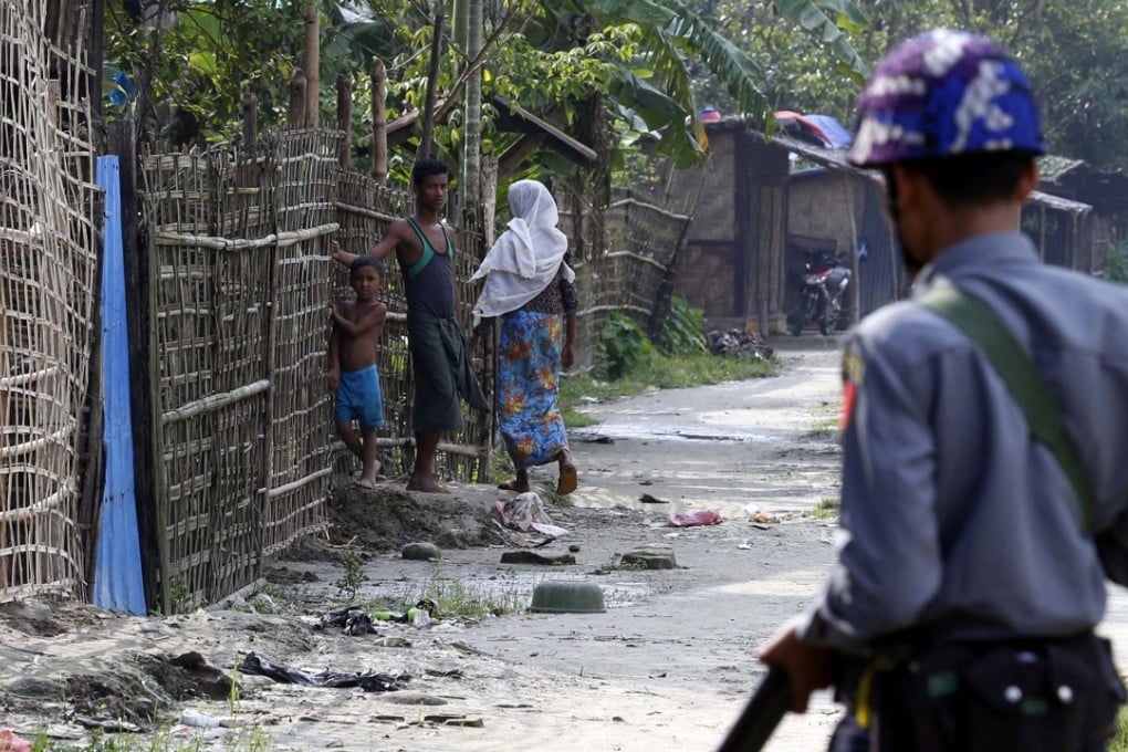A Myanmar policeman stands guard in Maungdaw township, Rakhine State. Photo: EPA