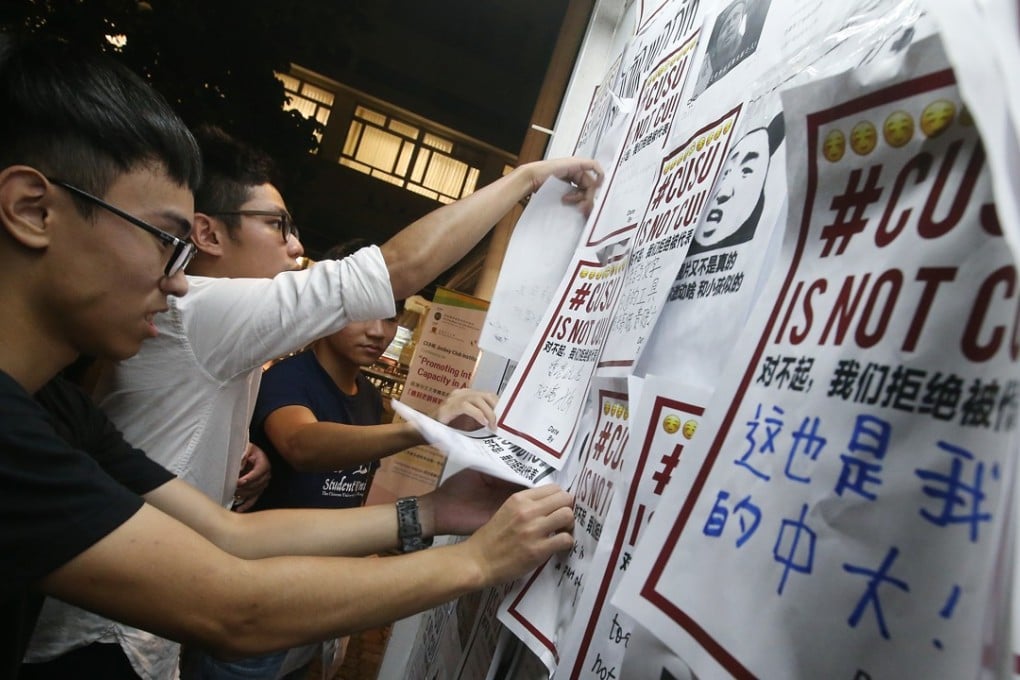 Members of Chinese University of Hong Kong's student union remove posters. Photo: K. Y. Cheng
