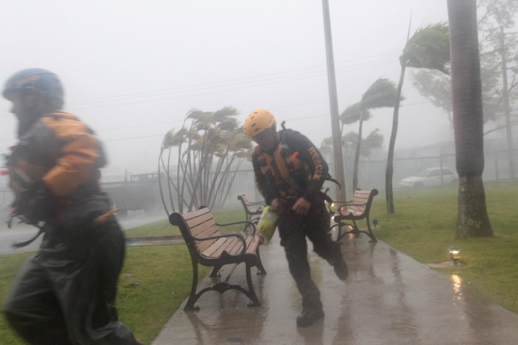 Members of the civil defence run as Hurricane Irma hits Fajardo, Puerto Rico, on Wednesday. Photo: Reuters