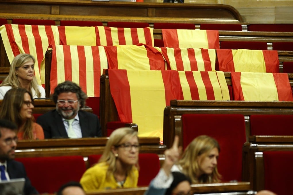 Spanish flags left behind by anti-independence members of the Catalan Popular Party who refused to vote on a bill to allow regional authorities to officially call an October 1 referendum on a split from Spain. Photo: AP