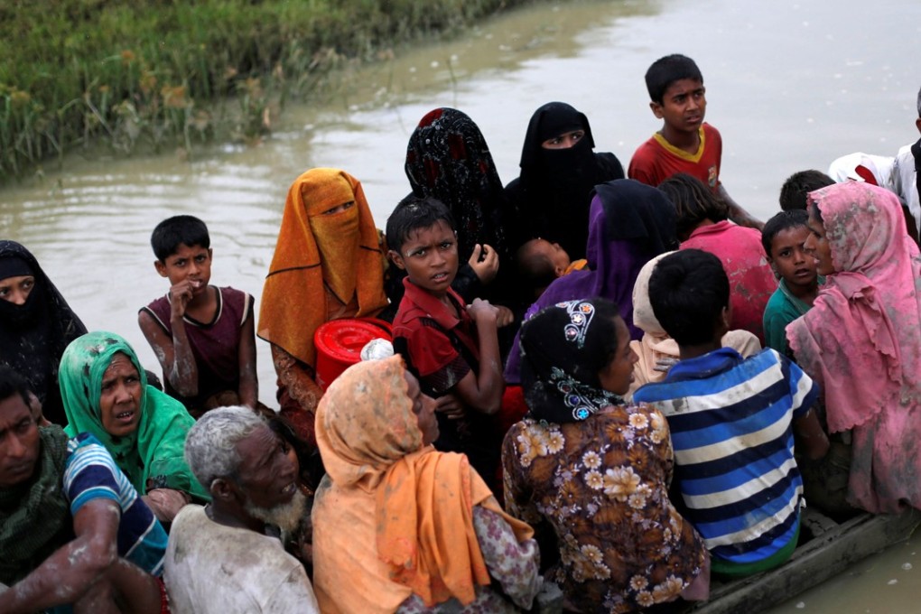 Rohingya ride a boat after crossing the Bangladesh-Myanmar border, in Teknaf, Bangladesh, September 6, 2017. Photo: Reuters