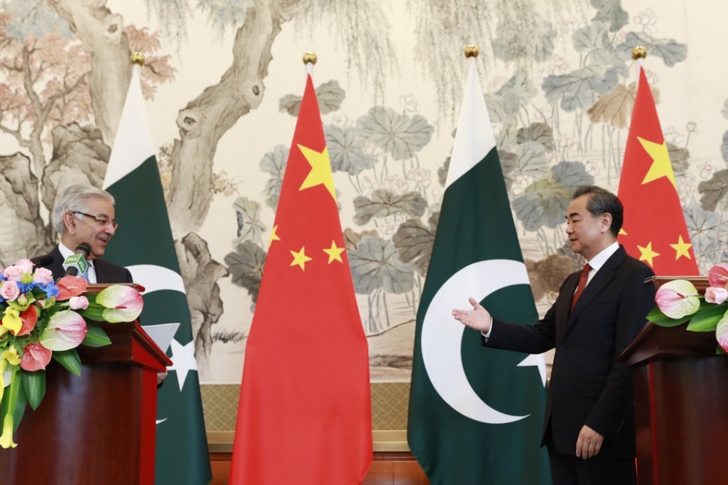 Chinese Foreign Minister Wang Yi (right) greets Pakistan Foreign Minister Khawaja Muhammad Asif at the Diaoyutai State Guesthouse in Beijing on Friday. Photo: EPA