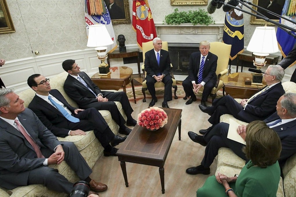 US President Donald Trump, centre right, speaks as House Majority Leader Kevin McCarthy, a Republican from California, from left, Steven Mnuchin, US Treasury secretary, US House Speaker Paul Ryan, a Republican from Wisconsin, US Vice President Mike Pence, Senate Majority Leader Mitch McConnell, a Republican from Kentucky, Senate Minority Leader Chuck Schumer, a Democrat from New York, and House Minority Leader Nancy Pelosi, a Democrat from California, listen during a meeting in the Oval Office of the White House. Photo: Bloomberg