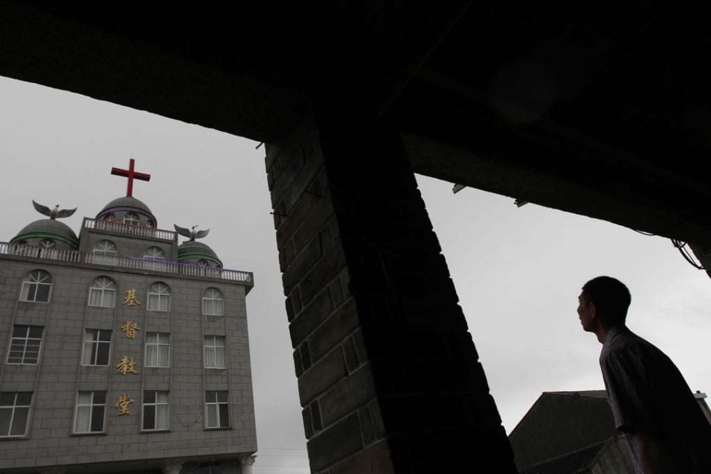 A man looks at the Lingbo Church at Pingyang county, Wenzhou city, Zhejiang province. Photo: Simon Song