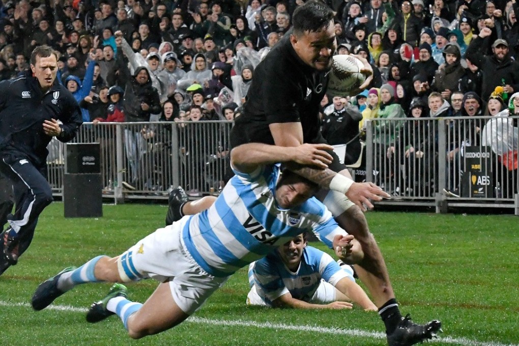 New Zealand’s Vaea Fifita (right) runs in a try as he is tackled by Argentina’s Santiago Cordero. Photo: AFP