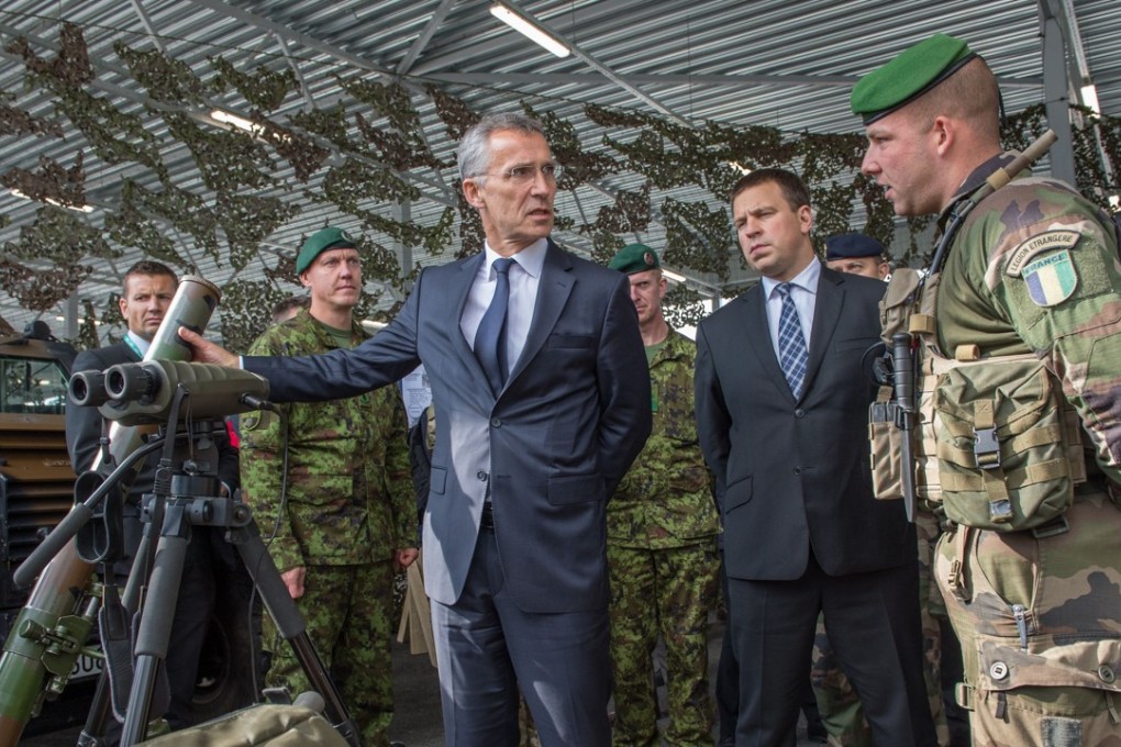 Nato Secretary General Jens Stoltenberg (L) and Estonia's Prime Minister Juri Ratas (C) visit a Nato battle group at Tapa military base, Estonia. Photo: AFP