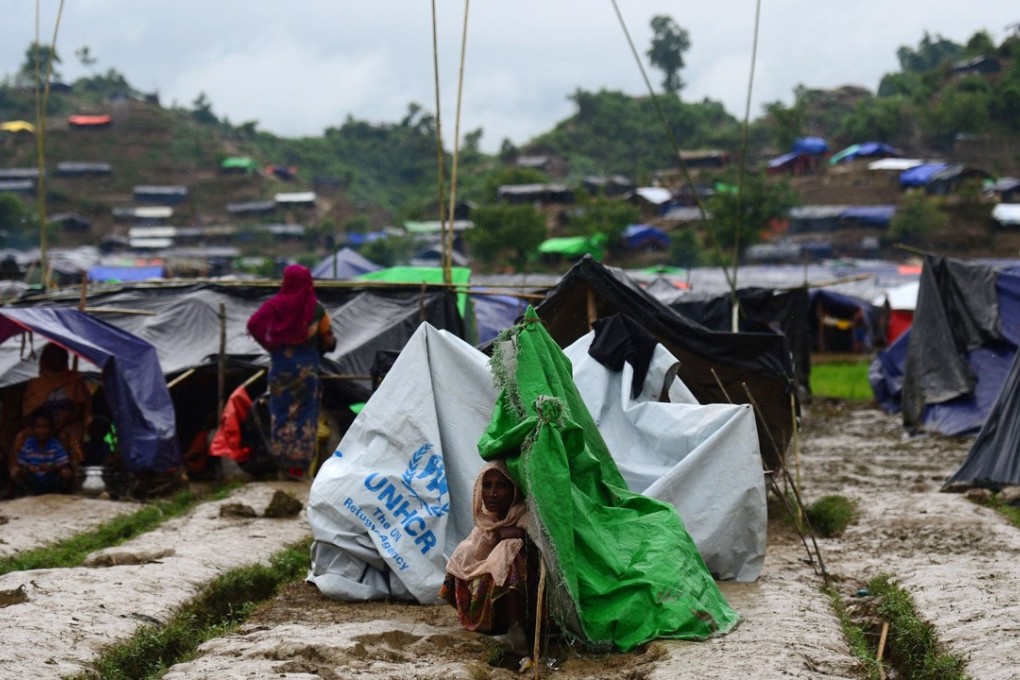 A Rohingya refugee woman sits next to a makeshift shelter in a camp in the Bangladeshi locality of Ukhia. Photo: AFP