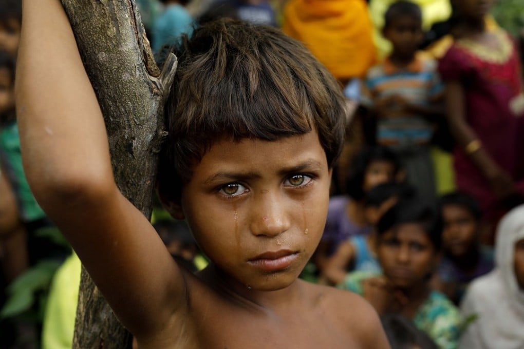 A tearful girl stands among other Rohingya refugees who arrived in Bangladesh on September 6 after fleeing from Myanmar. Photo: AFP
