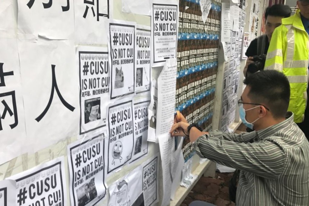 Students from Chinese University of Hong Kong post notice on "Wall of democracy" in campus. Photo: Elizabeth Cheung
