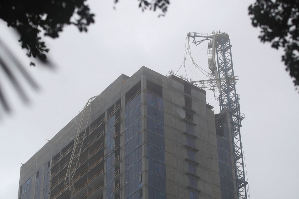 A mangled crane is seen draped over a building in Miami after it collapsed from the winds of Hurricane Irma on Sunday. Photo: AFP
