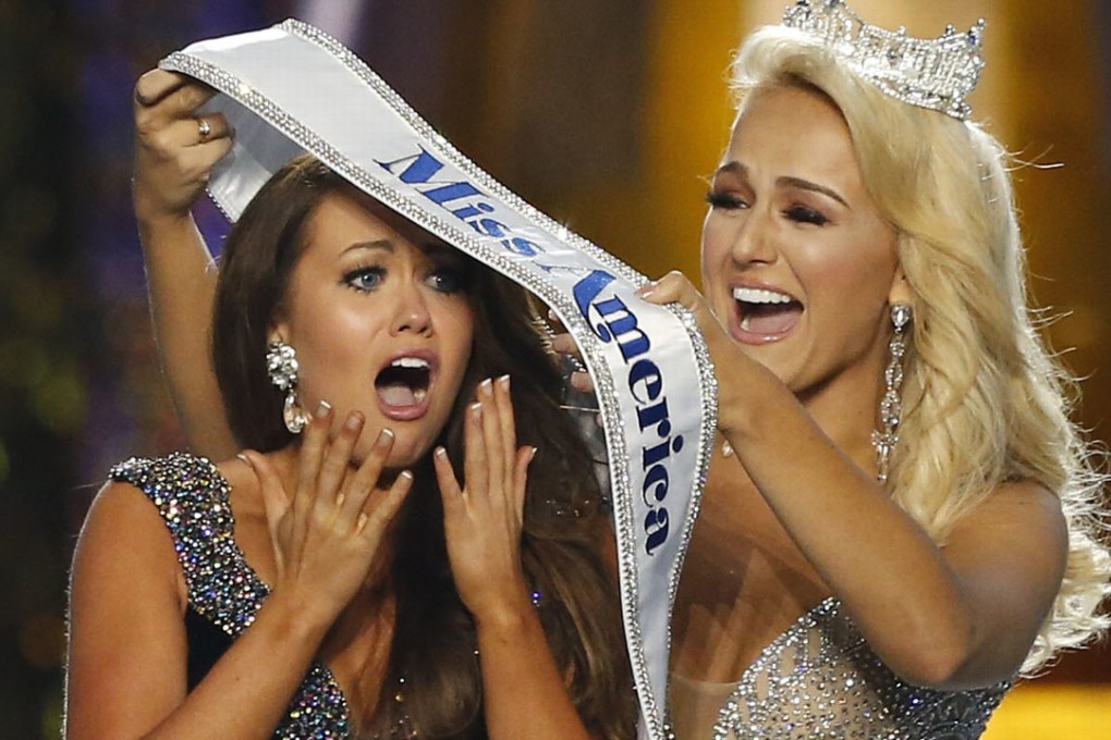 Miss North Dakota Cara Mund (left) reacts after being named Miss America during Miss America 2018 pageant in Atlantic City, New Jersey. She receives her winner’s sash from outgoing Miss America, Savvy Shields of Arkansas. Photo: AP