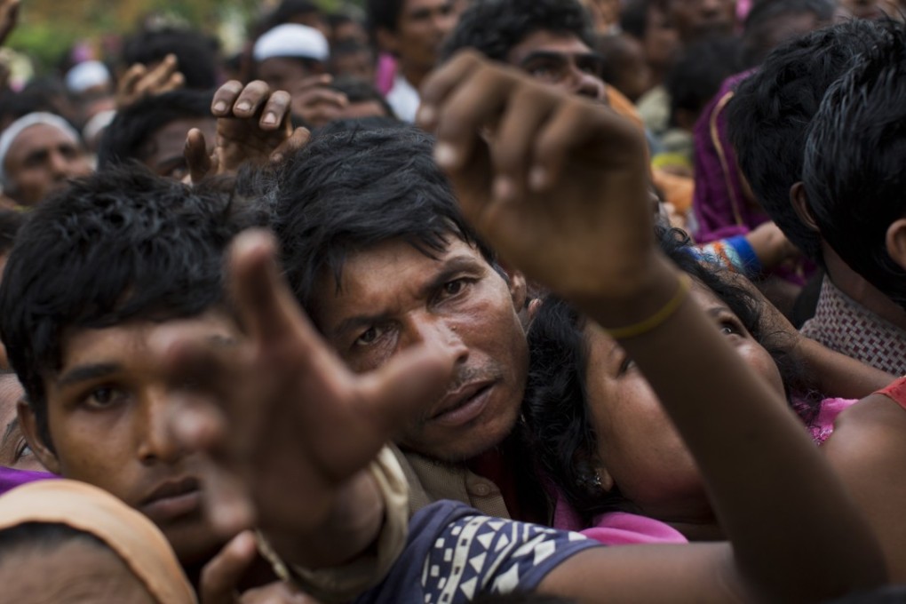 Rohingya refugees reach for food handed out by Bangladeshi volunteers near Cox's Bazar. Photo: AP