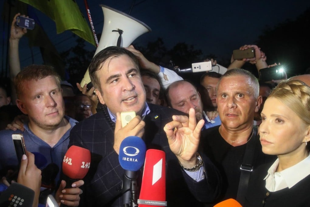 Former Georgian president and ex-Odesa Governor Mikhail Saakashvili (centre) speaks with journalists after he crossed Polish-Ukrainian border on Sunday. Photo: EPA